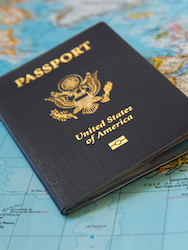 A United States passport lying on a world map.