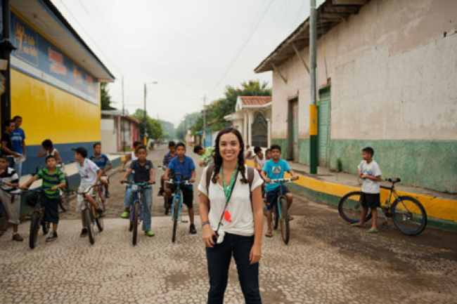 Peace Corps volunteer with children on bikes